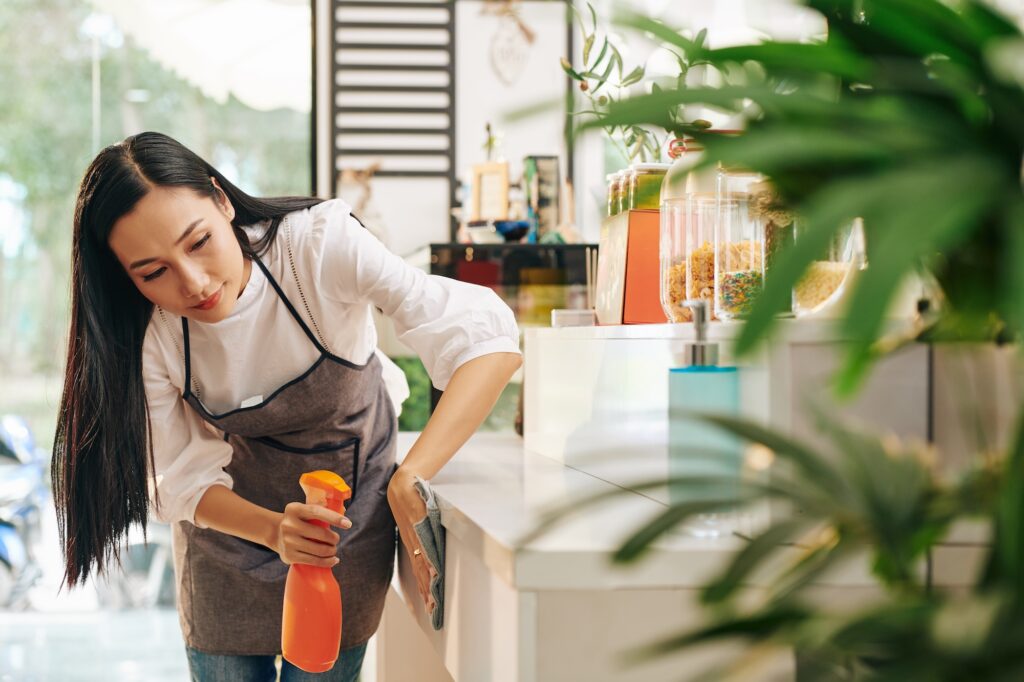 Office cleaner in greater Phoenix Arizona metro area cleaning a desk