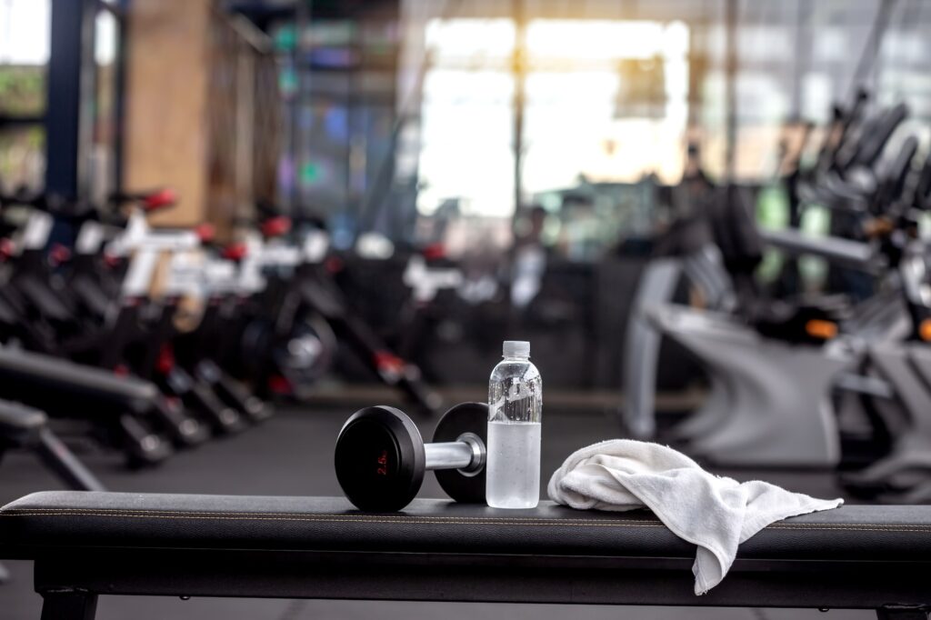 a gym fitness center weights bench gets cleaned by a cleaning company in phoenix