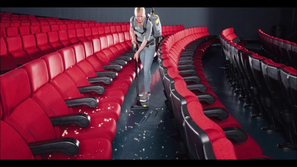 a woman from a cleaning company vacuuming popcorn at a movie theater in chandler, Movie Theatre,