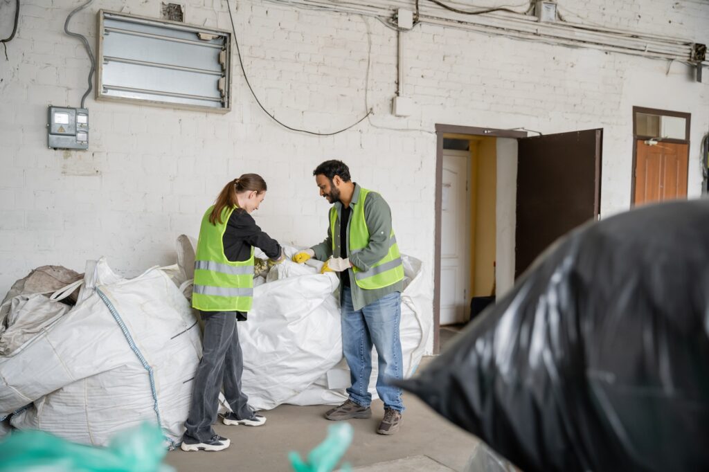 male and female cleaners from a commercial cleaning company packing trash for post construction in mesa