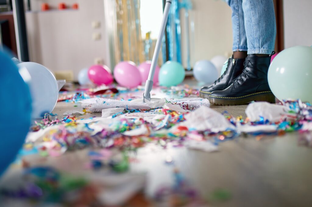 woman from a cleaning company pushes a broom after a birthday party in gilbert az