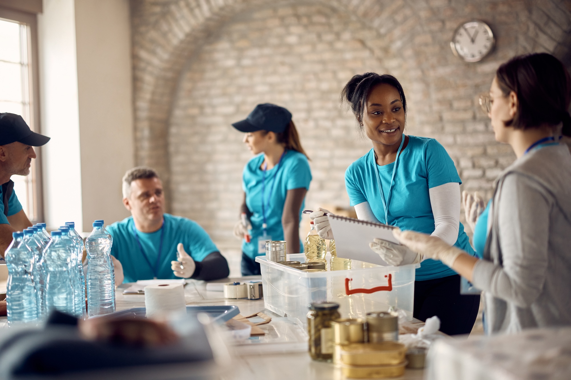 a group of workers from a cleaning company in scottsdale wipe down a table at an event venue for a wedding